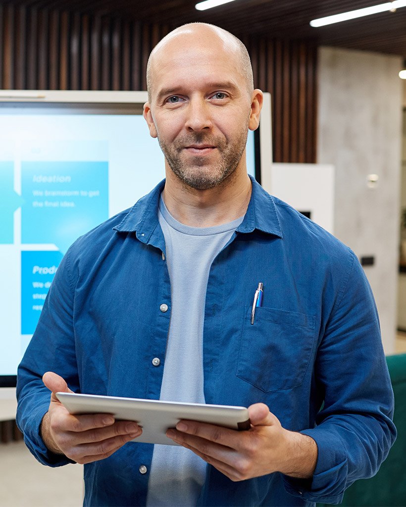 modern bald manager standing at digital board pmvswnf.jpg